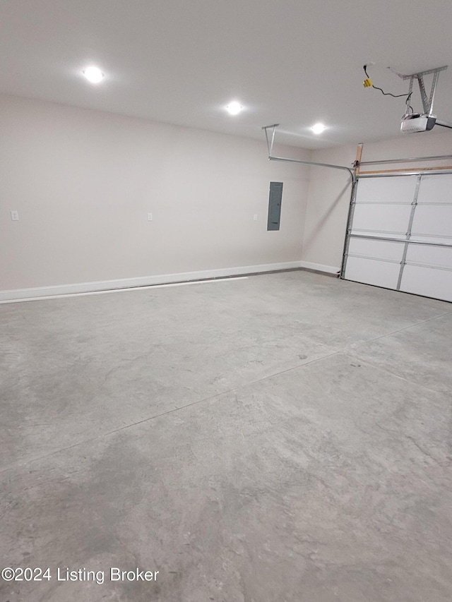 garage with a garage door opener and electric panel