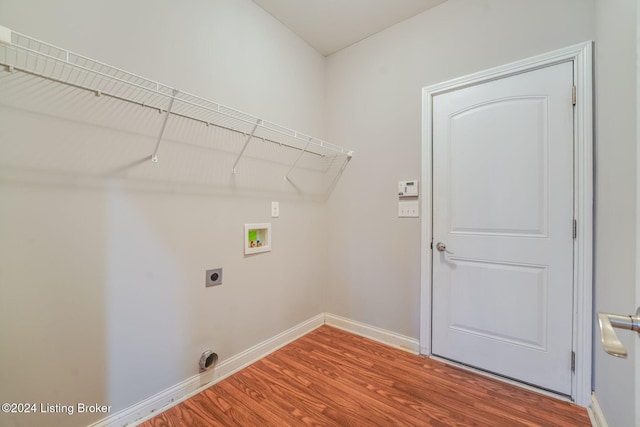 washroom with electric dryer hookup, hookup for a washing machine, and wood-type flooring