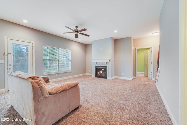 living room featuring light carpet and ceiling fan