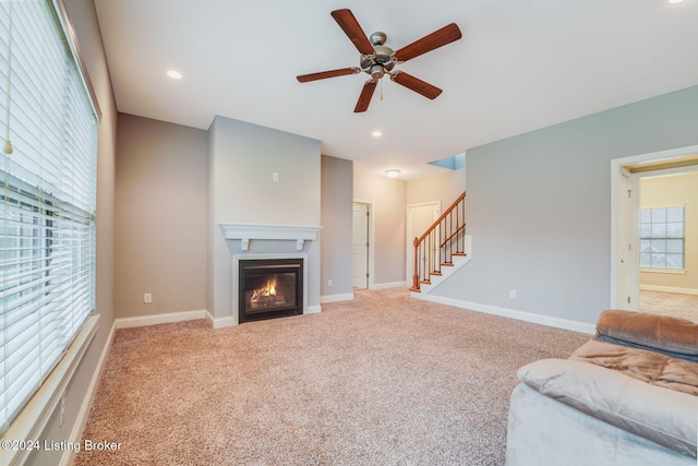 living room featuring ceiling fan and light colored carpet