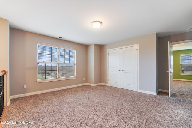 unfurnished bedroom with carpet and a closet