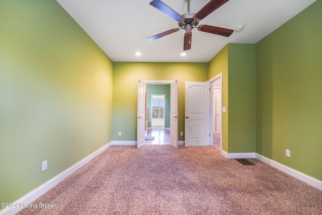 empty room featuring light carpet and ceiling fan