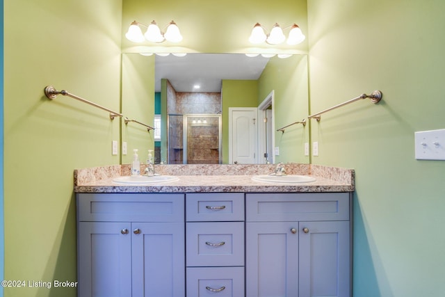 bathroom featuring vanity and a shower with shower door