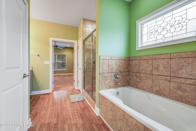 bathroom with separate shower and tub, ceiling fan, and hardwood / wood-style flooring