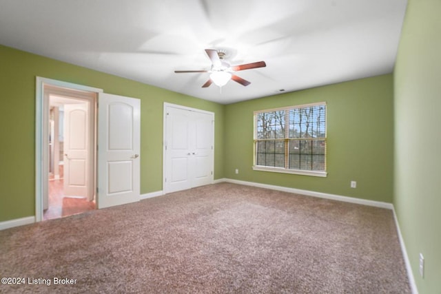 unfurnished bedroom with ceiling fan and carpet floors