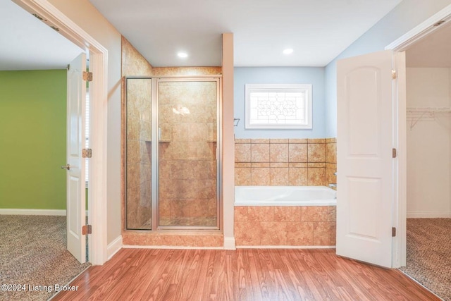 bathroom featuring hardwood / wood-style flooring and separate shower and tub