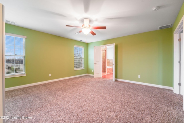 unfurnished bedroom featuring carpet, ceiling fan, and connected bathroom