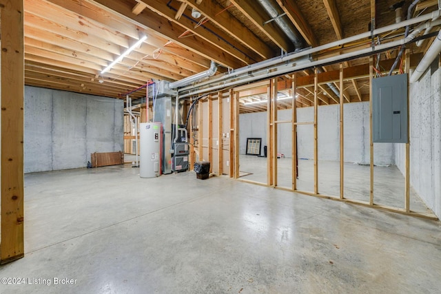 basement featuring electric panel and electric water heater