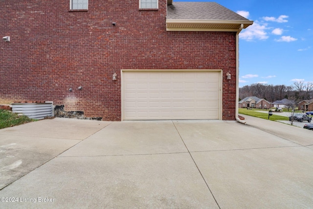 view of side of home featuring a garage