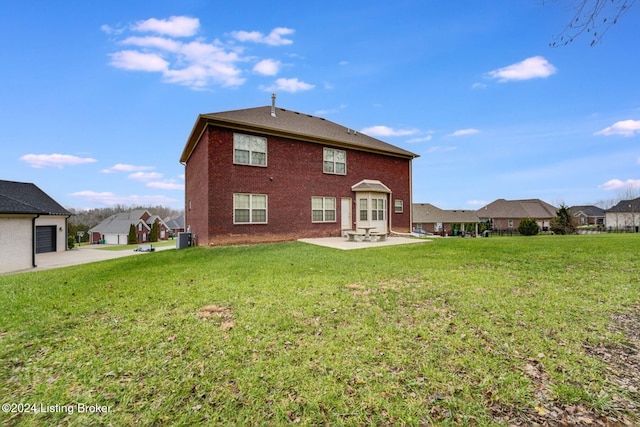 back of property with a lawn and a patio area