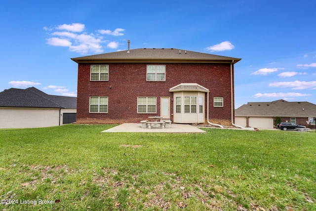 rear view of property featuring a yard and a patio