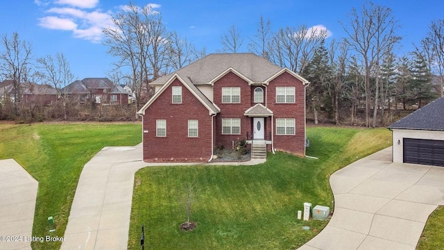 view of front of house with a garage and a front lawn