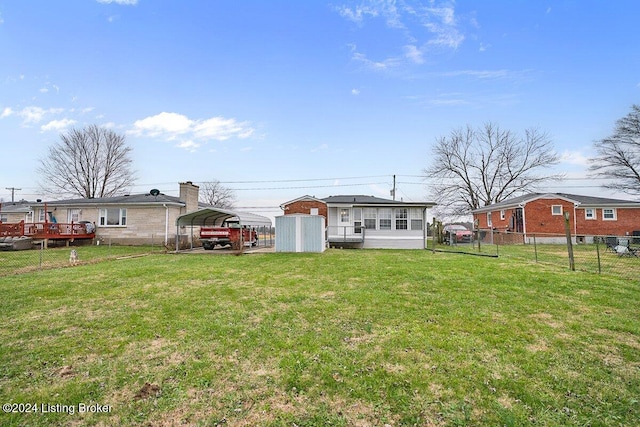 rear view of house featuring a carport and a lawn