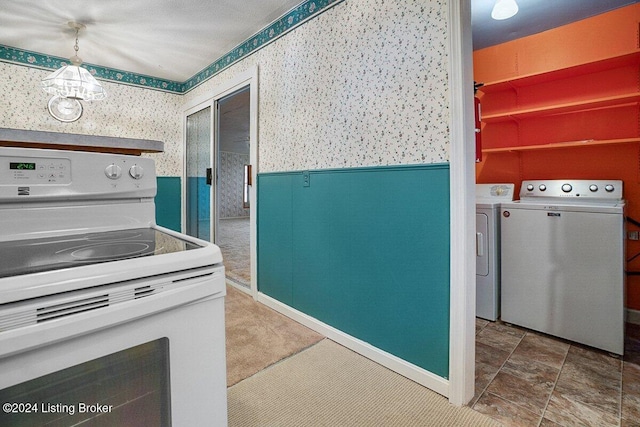 kitchen with washer and dryer, electric stove, and hanging light fixtures