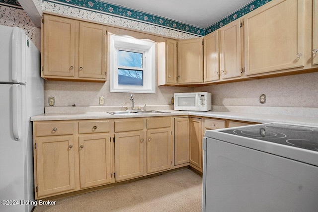 kitchen with light brown cabinetry, sink, light colored carpet, and white appliances