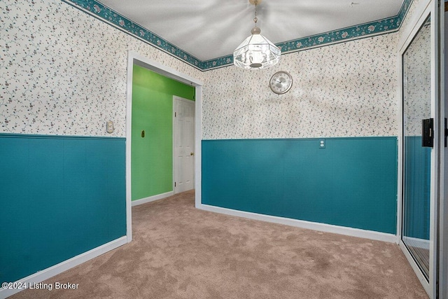 carpeted empty room with a textured ceiling