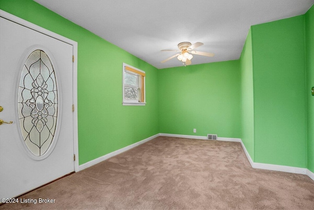 carpeted entryway with ceiling fan