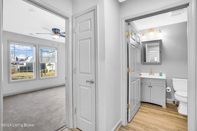 bathroom featuring ceiling fan, vanity, and toilet