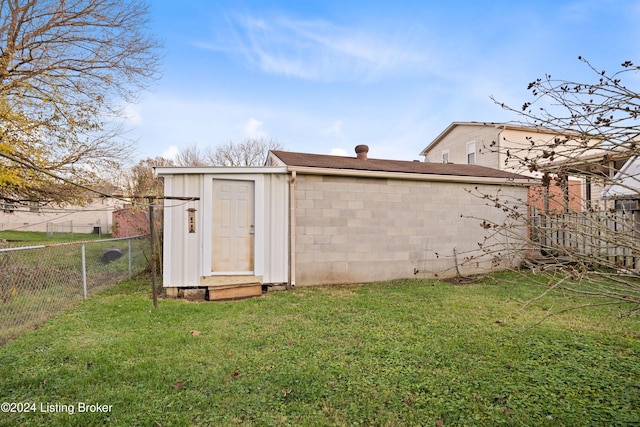 view of outdoor structure featuring a lawn