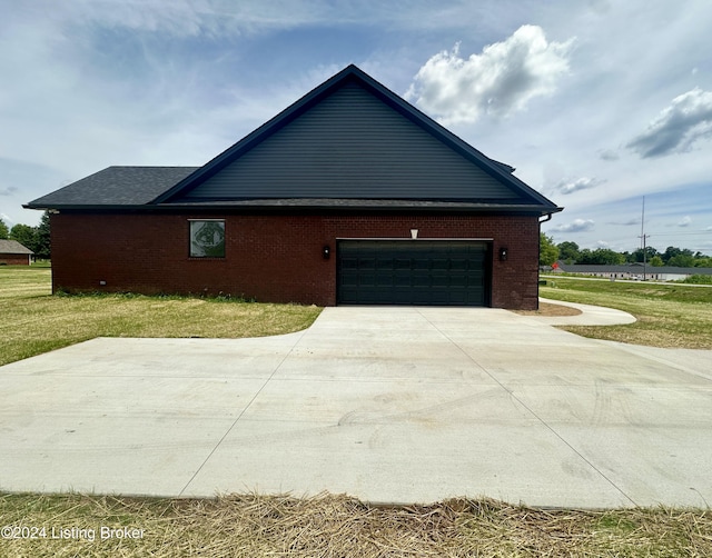 view of home's exterior with a garage and a yard