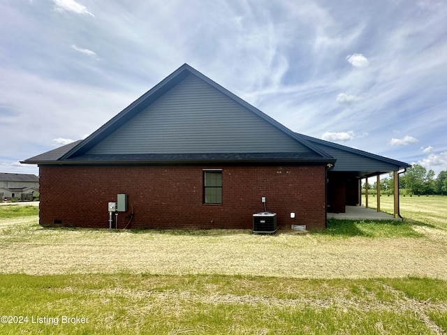 view of side of home with a patio and central AC