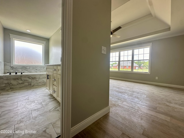 bathroom featuring wood-type flooring, vanity, and a bathing tub