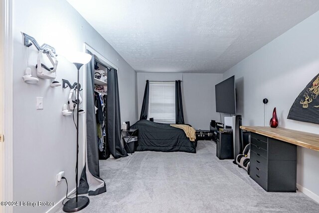 carpeted bedroom featuring a textured ceiling