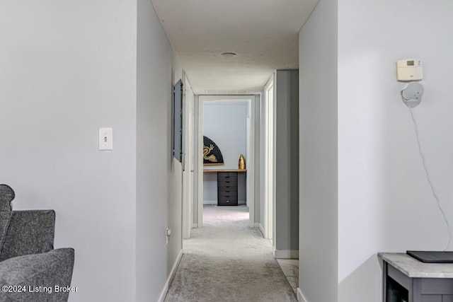 hallway featuring light carpet