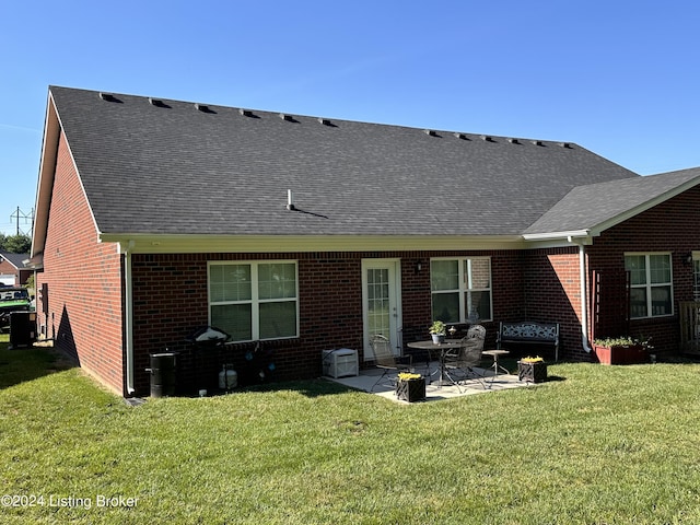 back of house featuring a yard and a patio