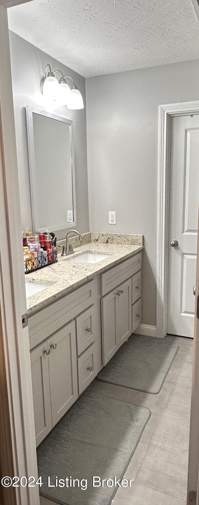 bathroom with vanity and a textured ceiling