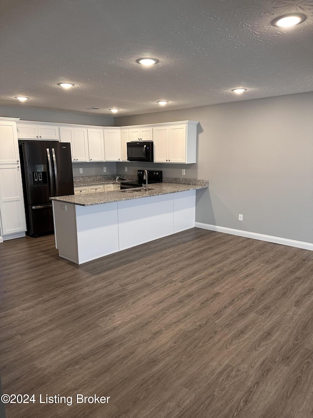 kitchen with kitchen peninsula, white cabinetry, black appliances, and dark hardwood / wood-style floors