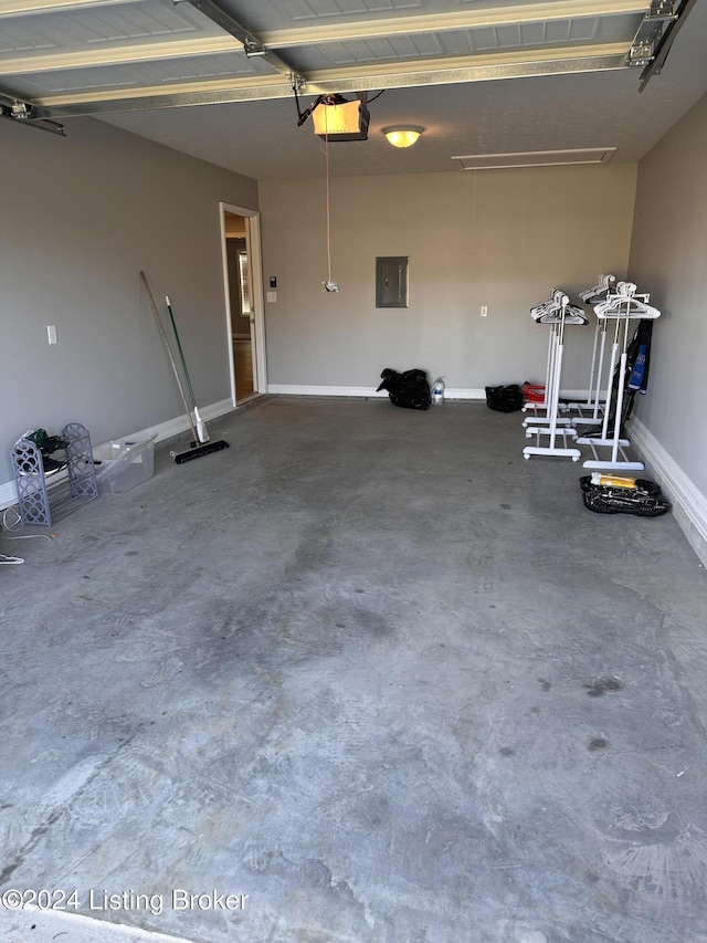 garage with electric panel and a garage door opener