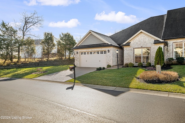 view of front of home featuring a front yard and a garage