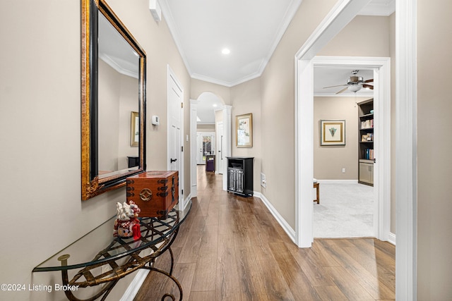 corridor featuring crown molding and hardwood / wood-style floors