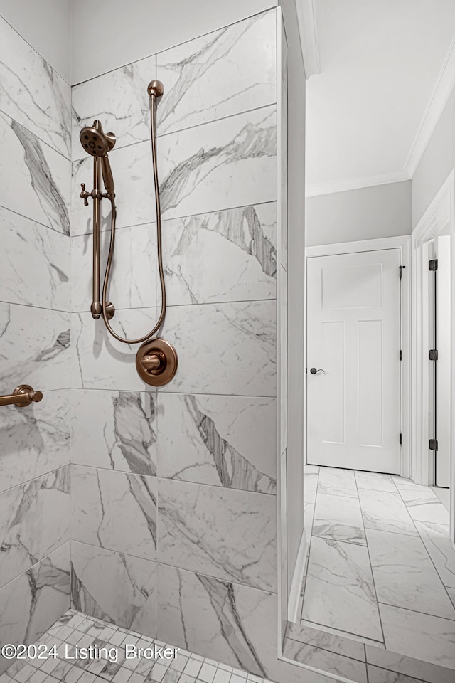 bathroom featuring tiled shower and crown molding