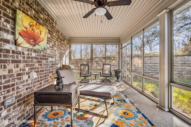 sunroom featuring ceiling fan and wooden ceiling