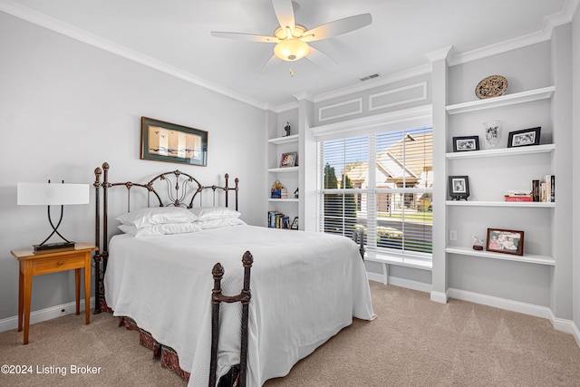 carpeted bedroom featuring ceiling fan and crown molding