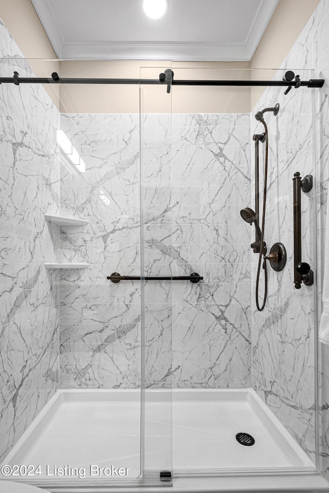 bathroom featuring an enclosed shower and ornamental molding