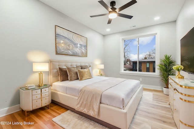 bedroom featuring ceiling fan and light hardwood / wood-style flooring