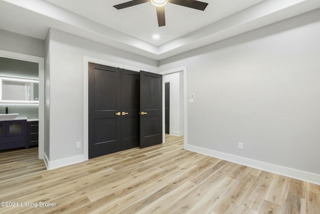 unfurnished bedroom with ceiling fan and light wood-type flooring