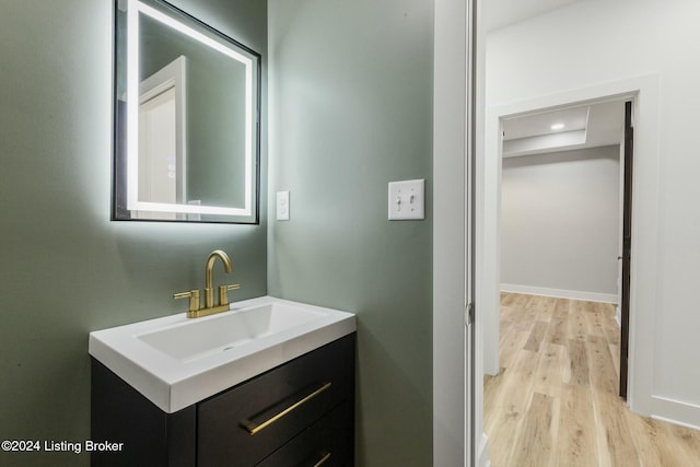 bathroom with hardwood / wood-style flooring and vanity