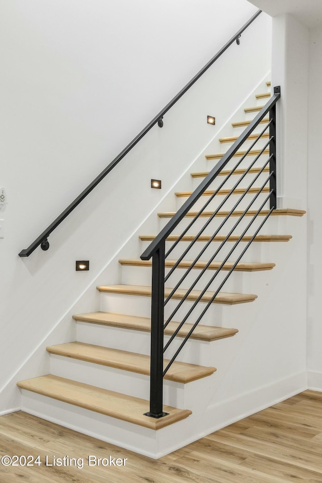 stairs with hardwood / wood-style flooring