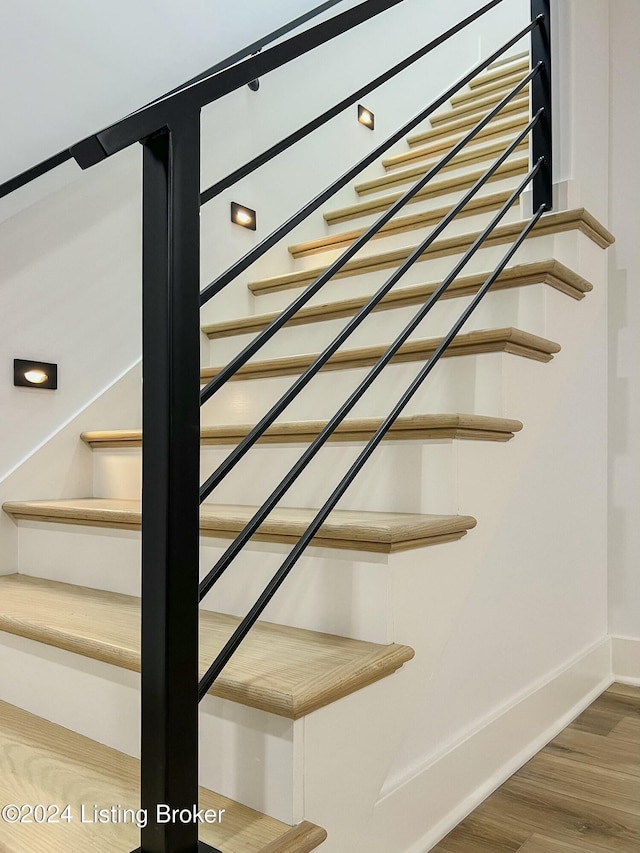 stairs with hardwood / wood-style flooring