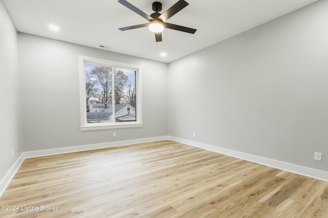 spare room with ceiling fan and light wood-type flooring