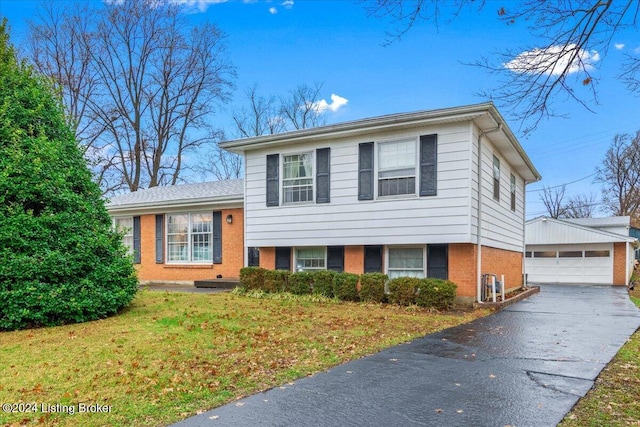 tri-level home with an outbuilding, a front lawn, and a garage