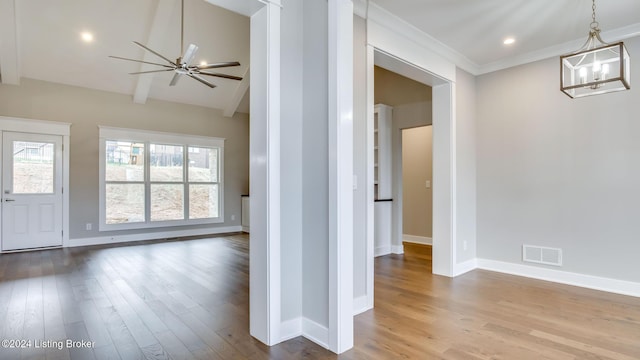 interior space featuring ceiling fan, crown molding, light hardwood / wood-style floors, and vaulted ceiling