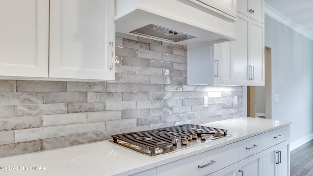 kitchen with hardwood / wood-style flooring, white cabinetry, and range hood