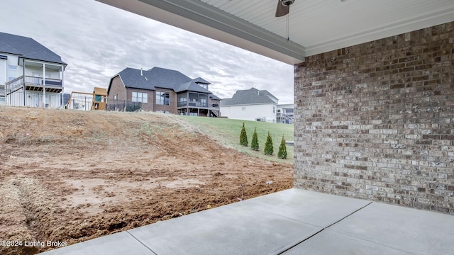 view of yard featuring ceiling fan and a patio area