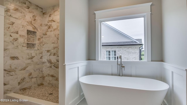 bathroom featuring independent shower and bath