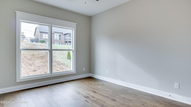 empty room featuring ceiling fan and light hardwood / wood-style floors